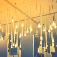 "Vintage Edison bulb pendant lights hanging from white ceiling with modern minimalist design elements"